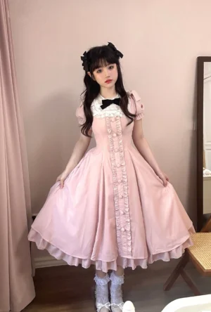 Pink vintage square neckline lolita OP dress with white lace collar trim and black bow detail full front body view