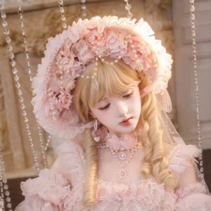 Pink wedding lolita bonnet headpiece with pearl chains and rhinestones, modeled with matching tulle dress and pearl choker on blonde lolita model in European palace interior setting