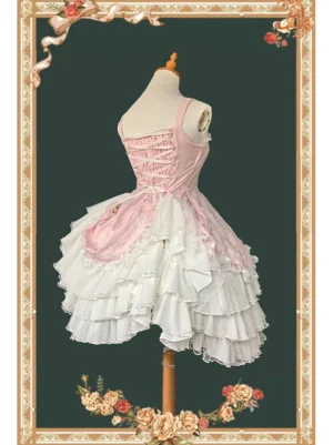 Pink and white classic lolita JSK dress with corset lace-up back design, layered ruffled hem, and square neckline displayed on dress form with ornate floral background frame
