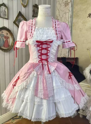 Pink and white classic lolita OP dress featuring red corset front lacing, short puffed sleeves, and multi-layered lace skirt on dress form