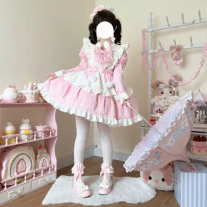 Model wearing pink and white maid lolita one-piece dress with bunny collar, white tights and pink Mary Jane shoes, full-body standing view in sweet tea party studio setting
