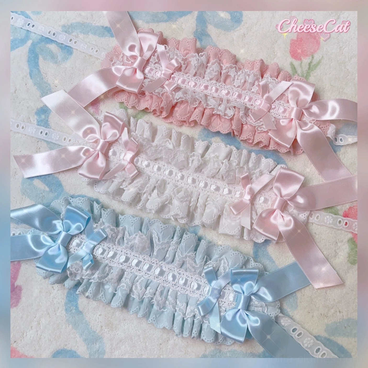 Pink and white Lolita lace hair headband with large satin bow and delicate embroidered ruffled lace trim detail from flat perspective