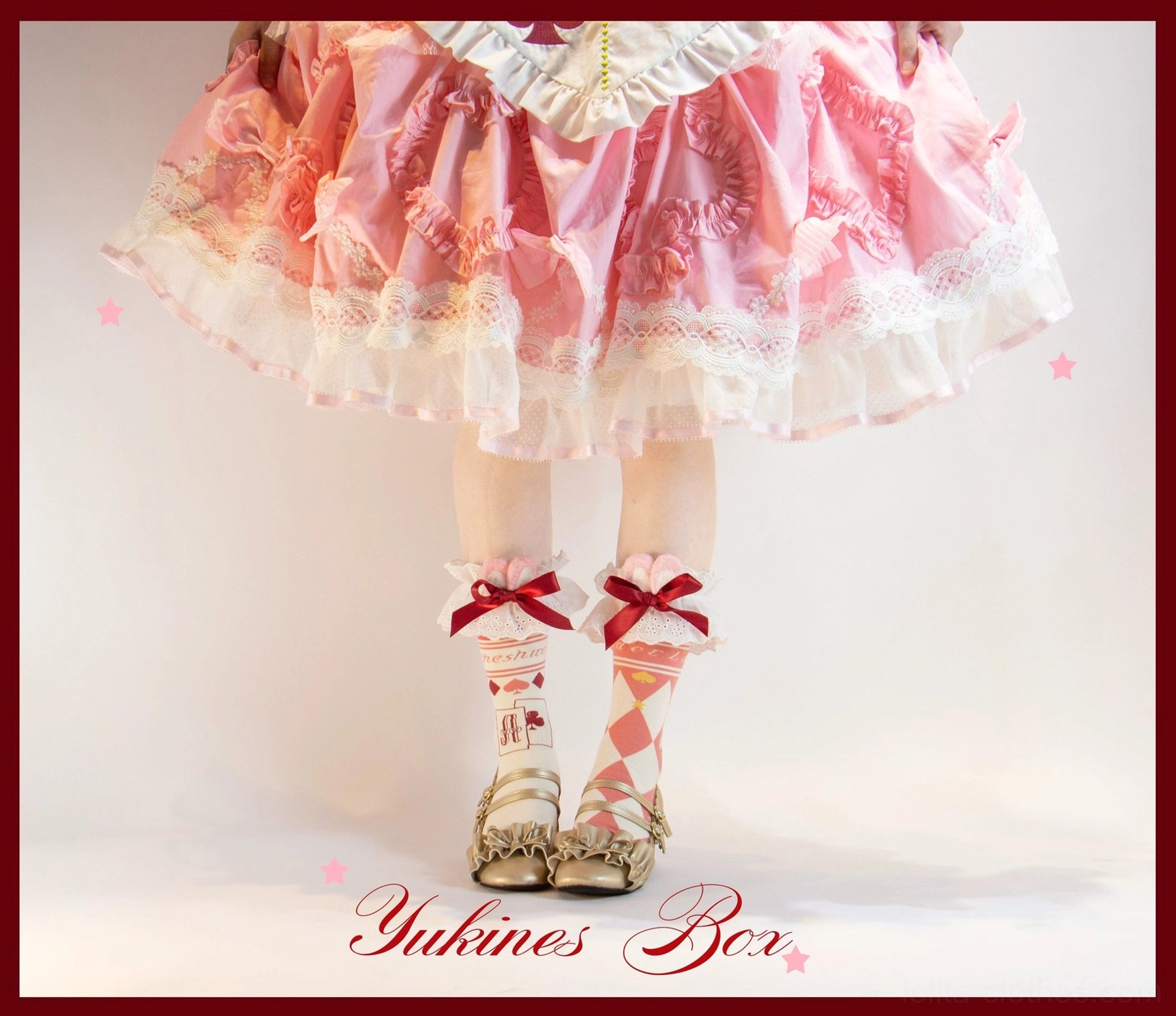 Pinkish red asymmetrical print lolita cotton over-the-knee socks worn with classic Alice dress vintage indoor scene photography