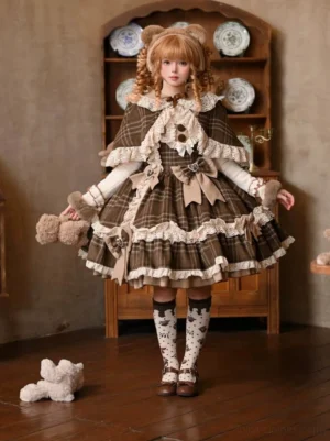 Full-body front shot of complete plaid Lolita coordinate with layered skirt, fuzzy cuffs, brown Mary Jane shoes and matching cape