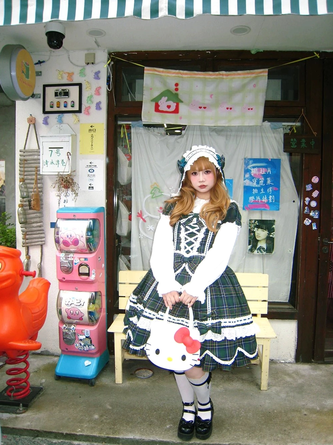 Full-length plaid lolita OP dress on model demonstrating fit, petal-shaped hem silhouette, bow placement, and Old School aesthetic with accessories