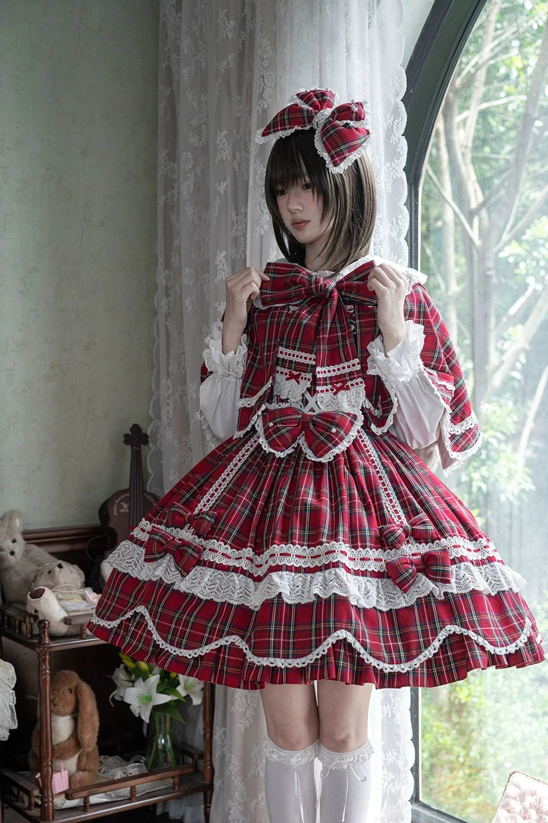 Plaid lolita OP dress back view highlighting large decorative bow, heart-shaped lace trim, and scalloped petal hem from rear