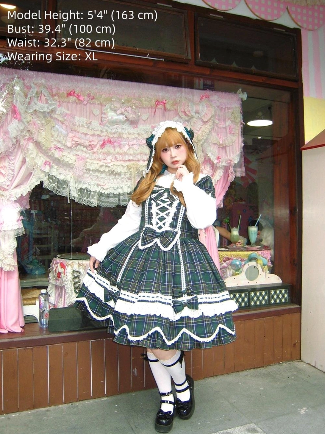 Close-up detail of plaid lolita dress showing pearl-adorned waist bow, refined bow decoration, and fabric texture of tartan pattern