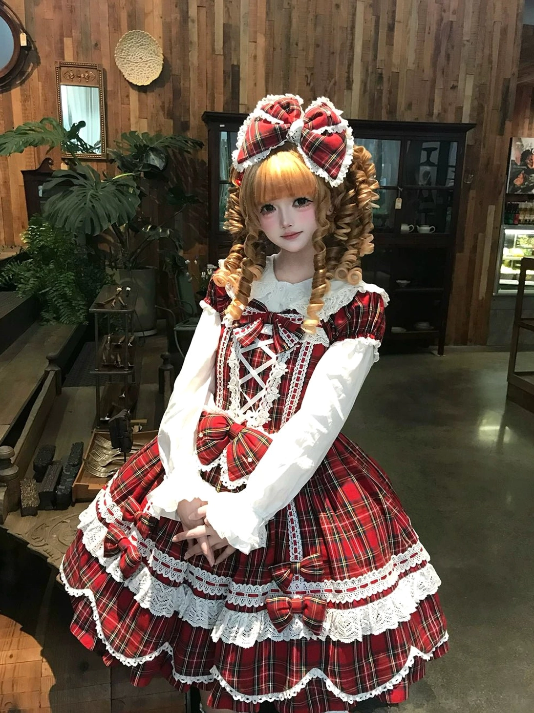 Plaid lolita OP dress hem detail showing petal-shaped scallops, white lace trim layering, and dimensional hemline construction