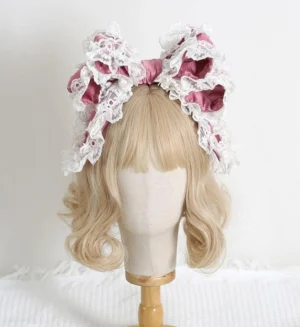 Plum pink delicate lace bow lolita hair accessory headband with frilled white lace edging on mannequin