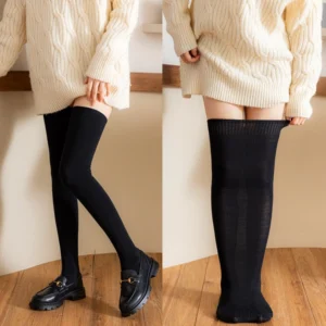 Plus-size lolita black cotton knee stockings full-length wearing view with cable knit sweater and loafers on wooden floor