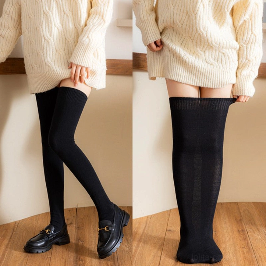 Plus-size lolita black cotton knee stockings full-length wearing view with cable knit sweater and loafers on wooden floor