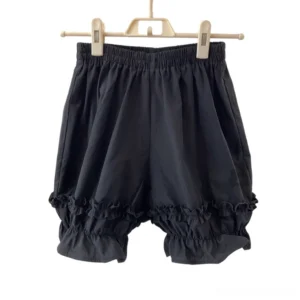 Plus-size lolita bloomers in classic black with relaxed pumpkin silhouette, front view on plastic hanger displaying double-layered ruffled leg cuffs and elastic waistband