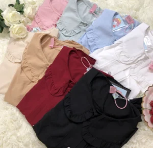 Plus size sweet Lolita long-sleeve blouse with ruffled Peter Pan collar in multiple color options including wine red light blue creamy white light pink black light green and ivory displayed in flat lay
