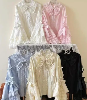 Plus size sweet lolita blouse with hime sleeves in blue pastel, featuring tiered lace ruffles, heart-shaped buttons, detachable bow collar, flat lay display showing multiple color options and front bow decorations on clothing rack