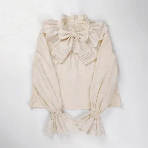 Plus size sweet lolita cotton blouse in ivory cream color with ruffled stand collar and large pleated bow detail flat lay photography