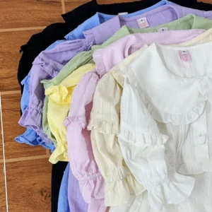 Plus size solid color sweet lolita short sleeve blouse flat lay overhead shot displaying full candy color range including black white cream pink apricot yellow blue purple options with ruffled peter pan collar and puff sleeves