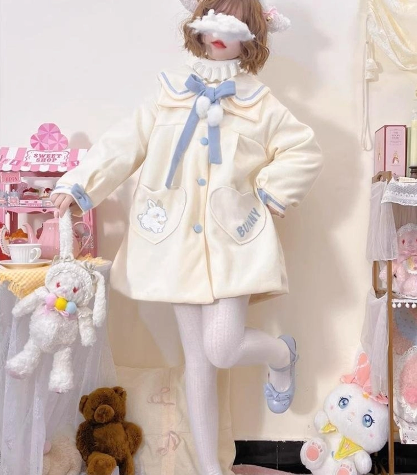 Plus size sweet lolita wool coat front full-body dynamic view model holding plush bunny toy surrounded by stuffed animals showcasing complete silhouette cream blue color scheme