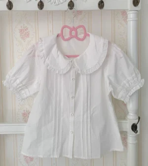 Plus size white cotton lolita blouse with peter pan collar and detachable ruffled princess sleeves displayed on pink bow hanger, front view showing pintuck details and round button placket