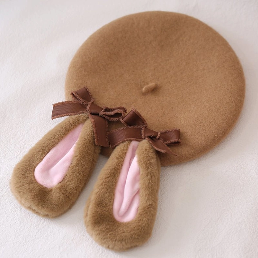 Overhead flat lay of complete rabbit ear beret showing full circular brown wool construction dual ribbon bows decoration