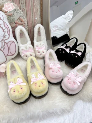 Flat lay overhead view of plush rabbit sweet lolita platform shoes in tender yellow, light pink, and black colorways on soft fur rug, showing fuzzy fleece texture and signature rabbit ear bow ornaments on each shoe