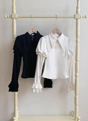 Elegant pointed collar Juliet sleeve lolita sweater in black and white on display rack featuring double-layered ruffled cuffs and classic lolita design