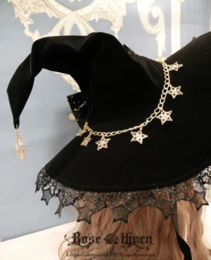 Classic pointed witch hat shape with black velvet material, star-shaped metal chain decoration, and lace edging brim - gothic lolita headpiece side back view
