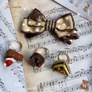 Polka-dot bow lolita hair clip with letter charm and resin dessert rings on vintage sheet music background