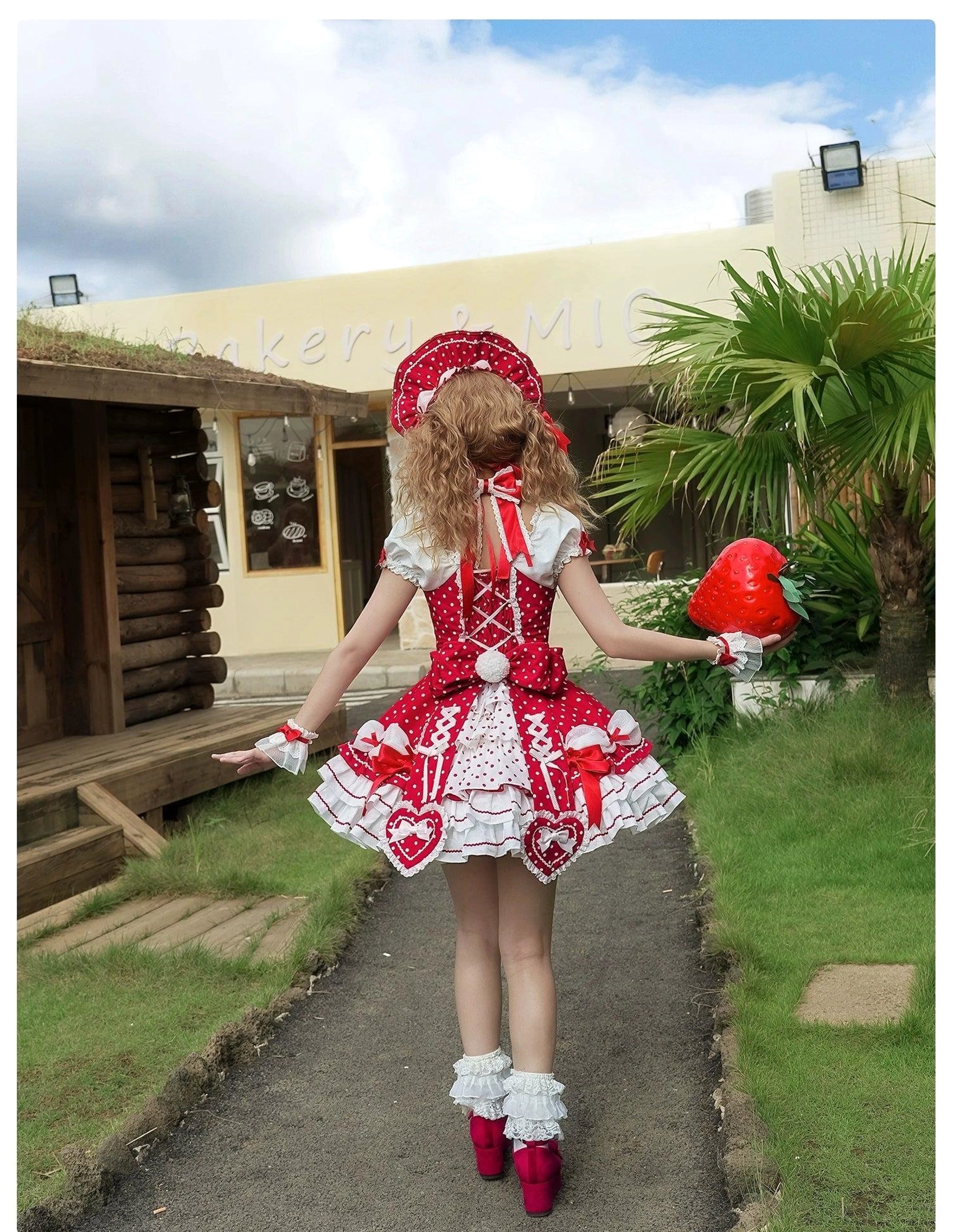 Polka dot Lolita halter dress worn by model from side angle showing silhouette volume and ruffled proportions