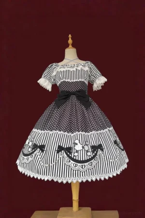 Black and white poodle lolita OP dress with poodle embroidery hem patches and faux pearl chains, featuring off-shoulder puff sleeves and patchwork polka dot stripe fabric design