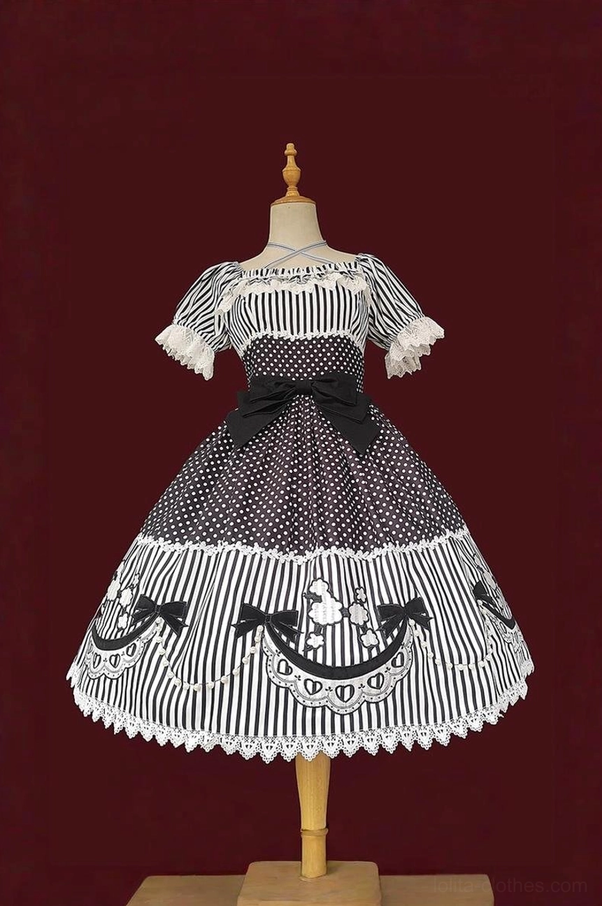 Black and white poodle lolita OP dress with poodle embroidery hem patches and faux pearl chains, featuring off-shoulder puff sleeves and patchwork polka dot stripe fabric design