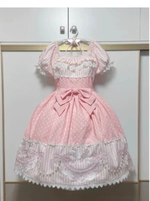 Front view of pink poodle polka dot old school lolita OP dress with detachable waist bow and poodle embroidery patches, displaying mixed polka dot and stripe brushed fabric