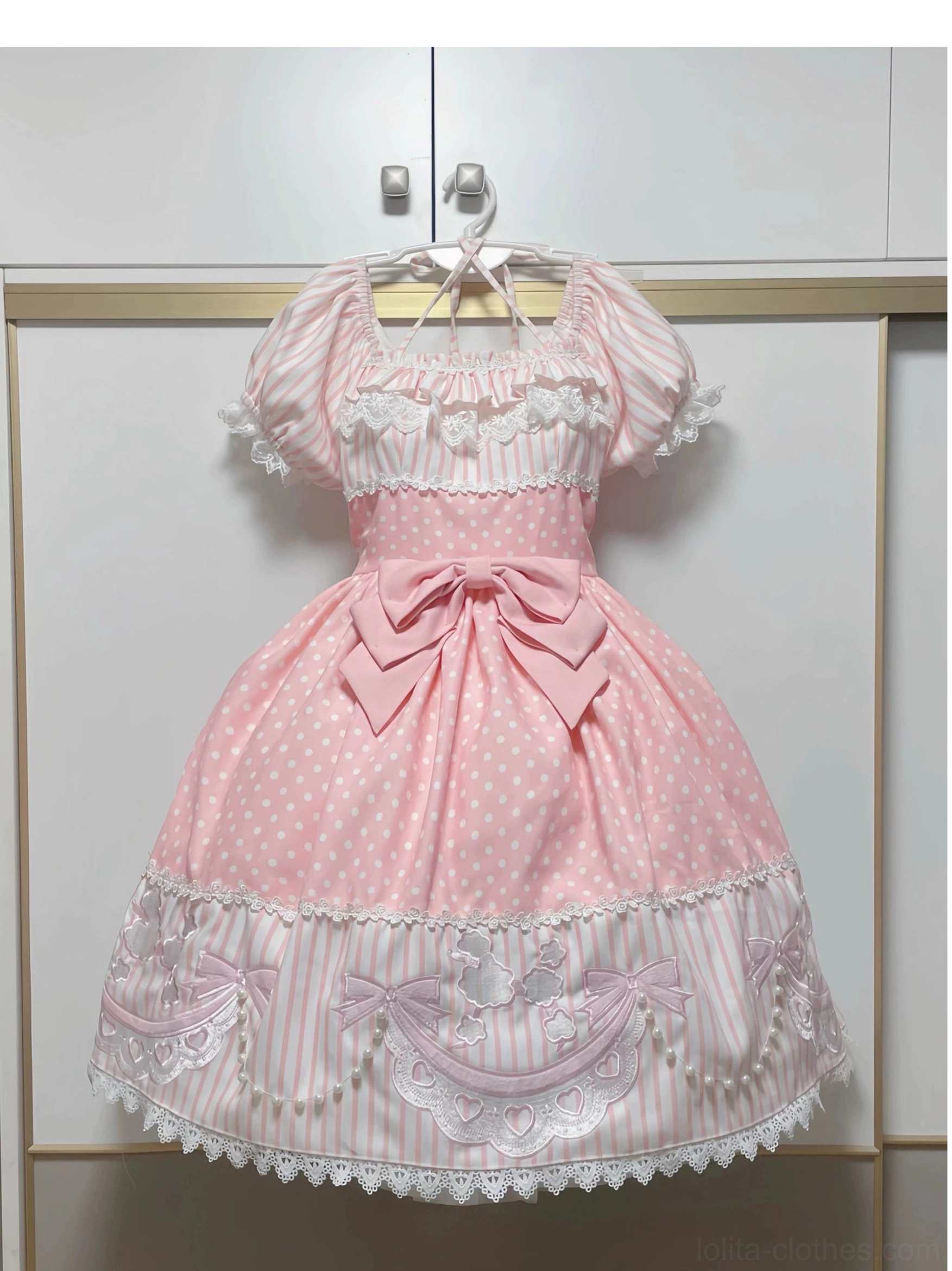 Front view of pink poodle polka dot old school lolita OP dress with detachable waist bow and poodle embroidery patches, displaying mixed polka dot and stripe brushed fabric