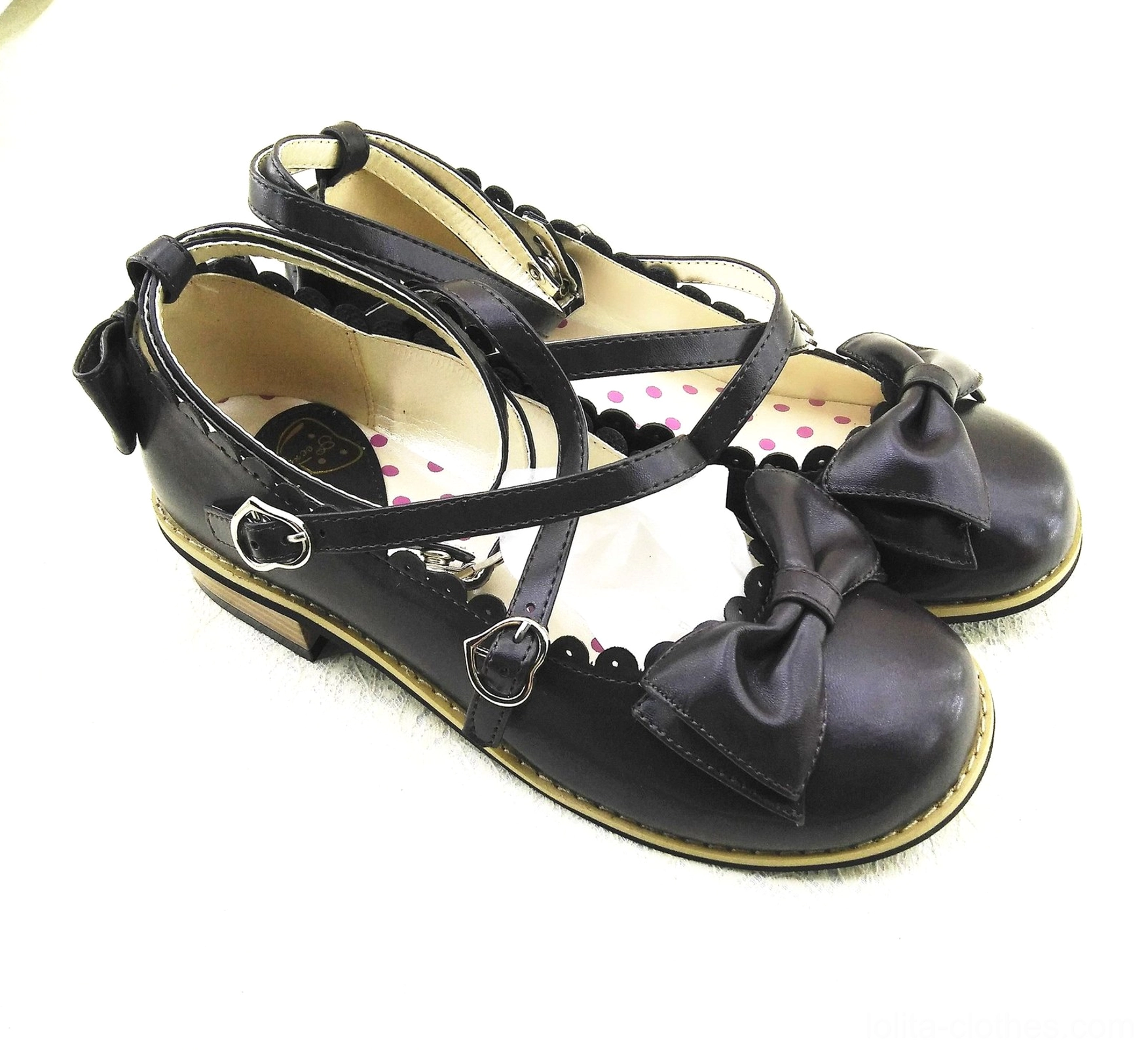 Powder blue Lolita low heel princess shoes with cross buckle ankle straps, coordinating blue bow decoration, polka dot inner sole, and classic Victorian-inspired silhouette design