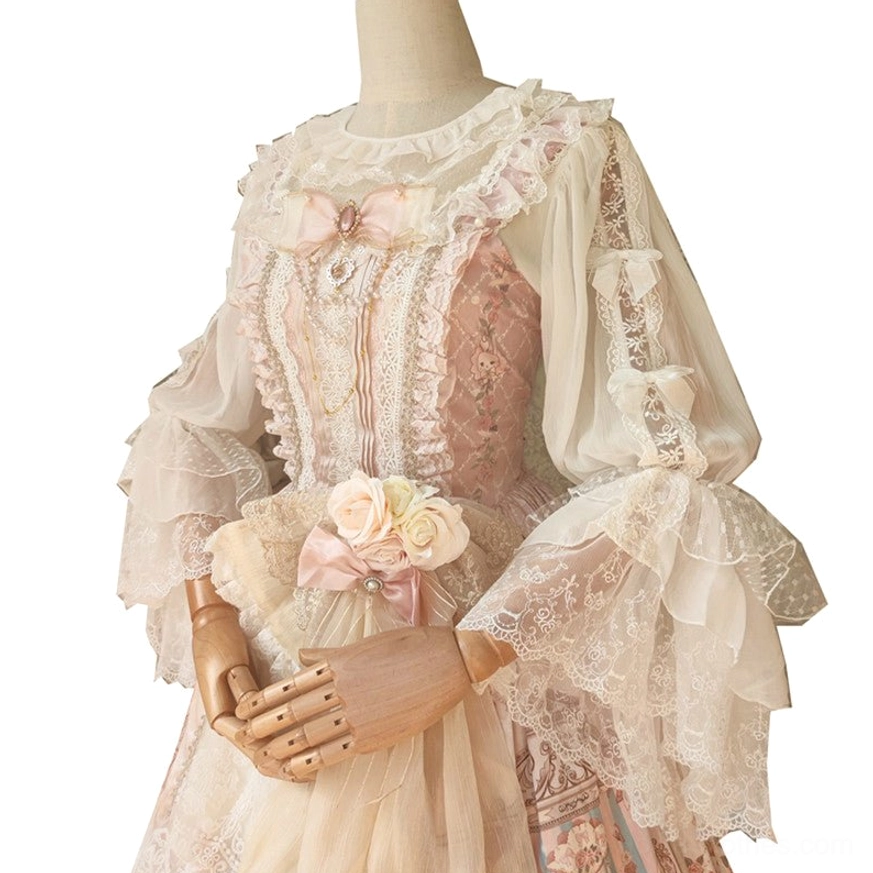 Lolita blouse with ruffled neckline embroidered lace bodice and flared lace sleeves with pink chest bow decoration against vintage wooden cabinet background