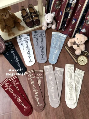 All eight color variations of printed Lolita calf socks displayed in flat lay arrangement with vintage props showing complete color palette from black to red in classic low-saturation tones