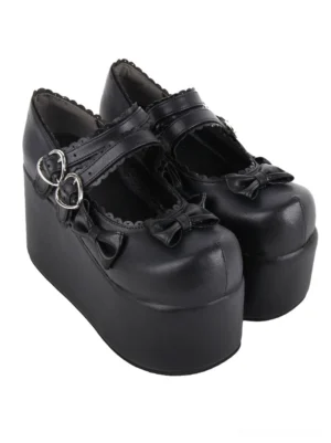 Black punk lolita high platform mary jane shoes with heart-shaped buckle straps and decorative front bows, three-quarter front view on white background