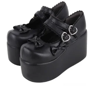 Detailed close-up front angled view of black punk lolita platform mary janes showing dual mary jane straps and ultra-thick wedge platform sole