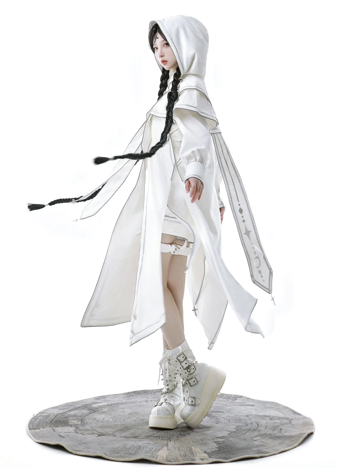 Side movement view of ethereal white cyber-lolita techwear ensemble with wind-blown hooded cape hem, clear silhouette of top and shorts, detailed laced platform footwear