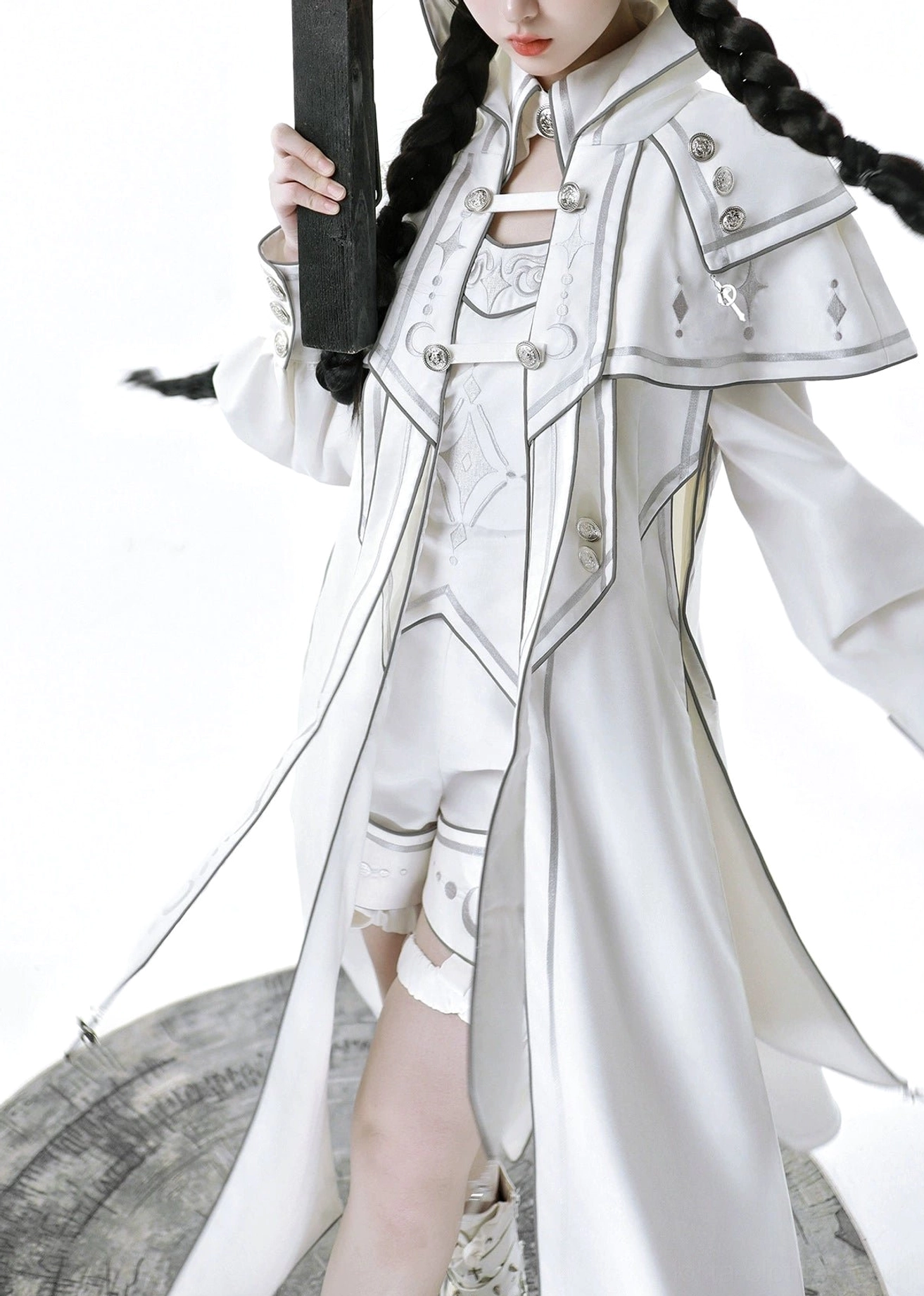 Detailed view of ethereal white lolita shorts featuring functional pockets, integrated leg harness system, high waistband structure, and silver button accents