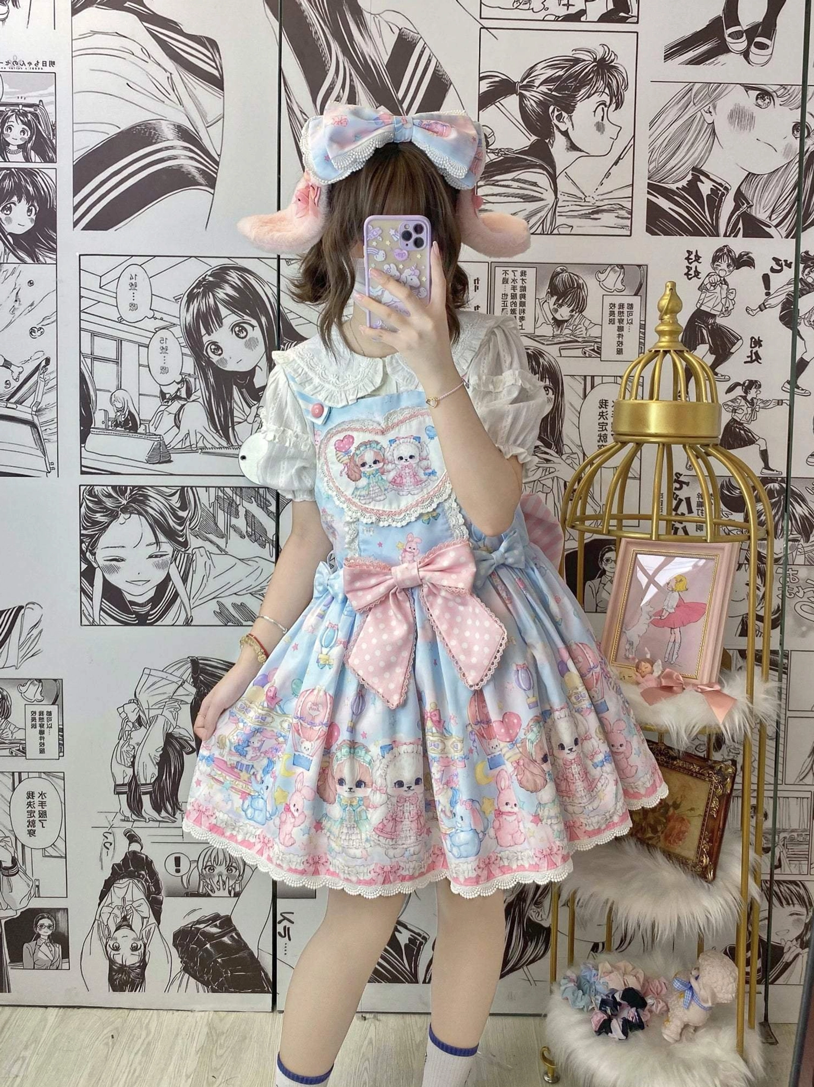 Pastel blue puppy Lolita salopette dress front mirror selfie with model showing Peter Pan collar heart shaped front yoke pink bow ruffled skirt hem kawaii aesthetic