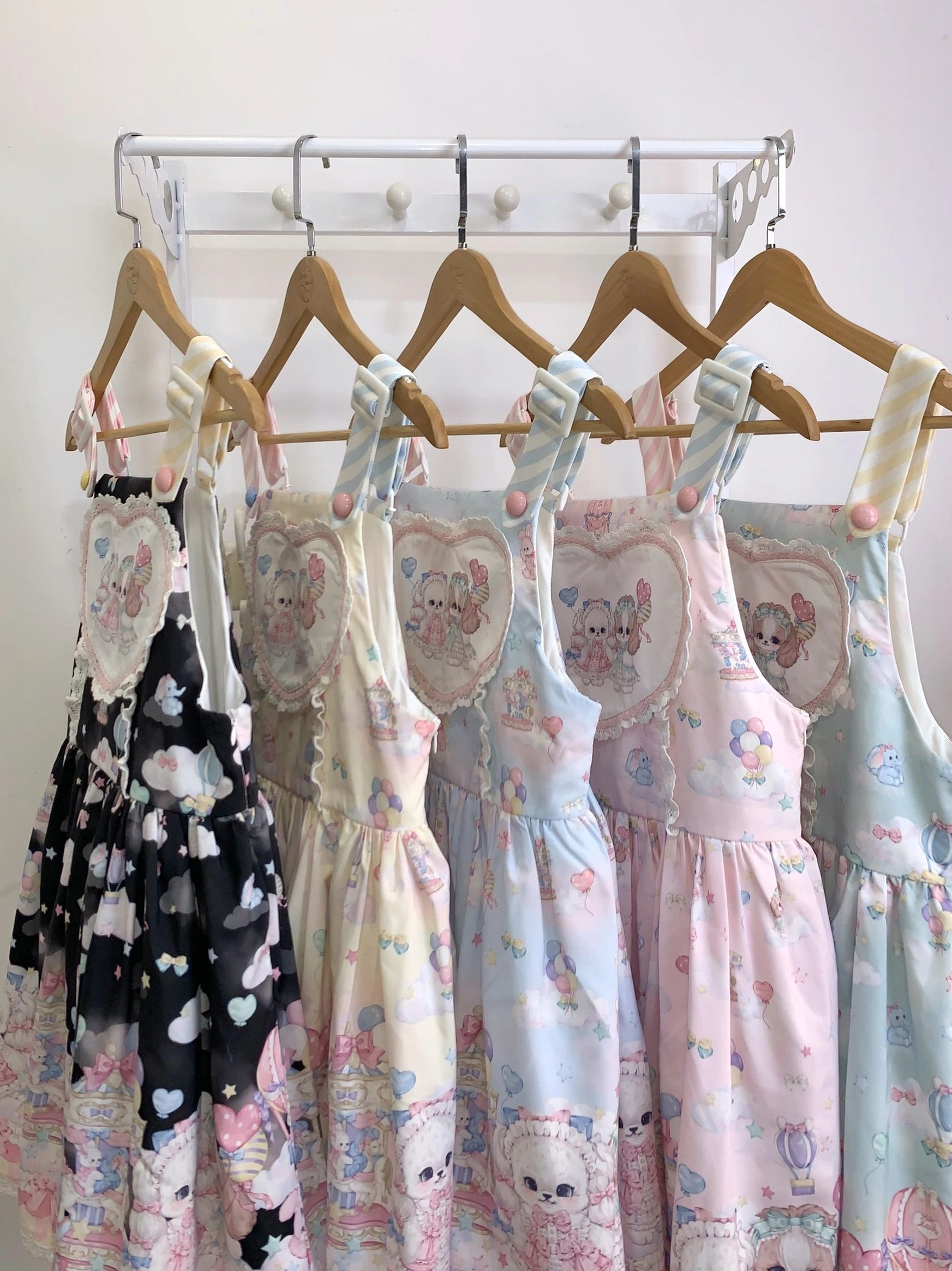 Pink puppy Lolita salopette front view showing heart bodice cute kawaii prints and sweet aesthetic design elements