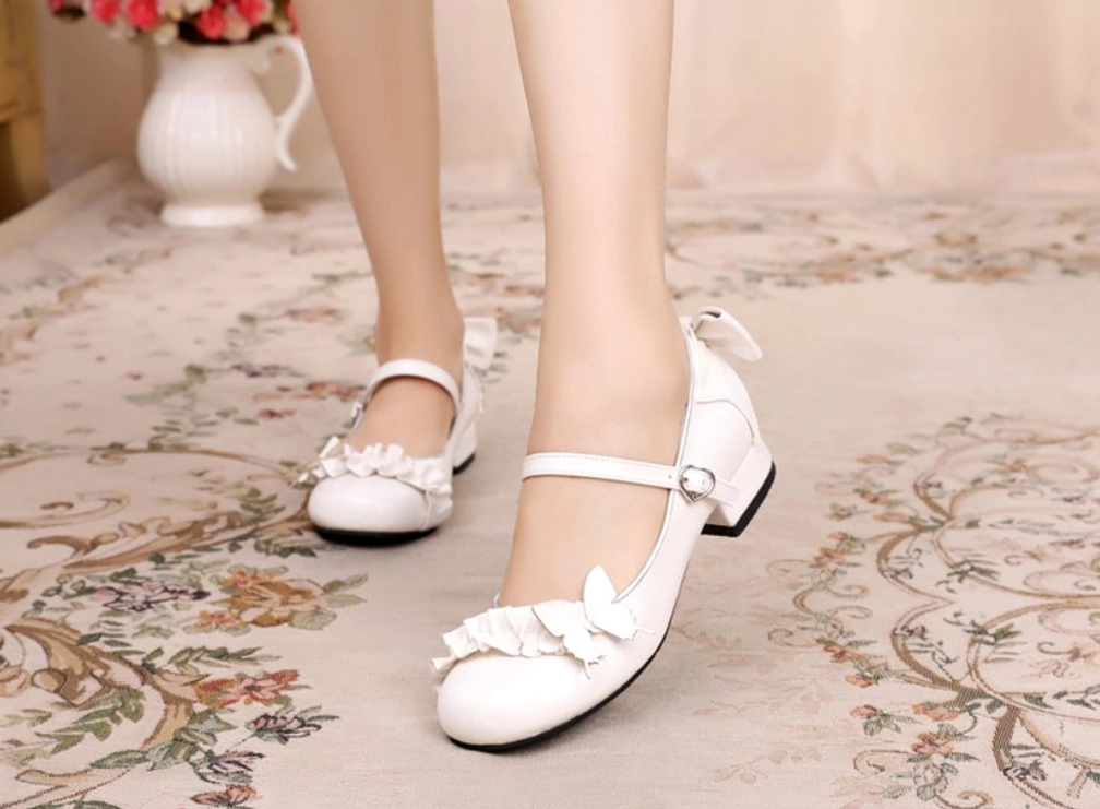 Pure white sweet Lolita Mary Jane shoes with butterfly and ruffle decorations heart shaped buckle strap indoor setting