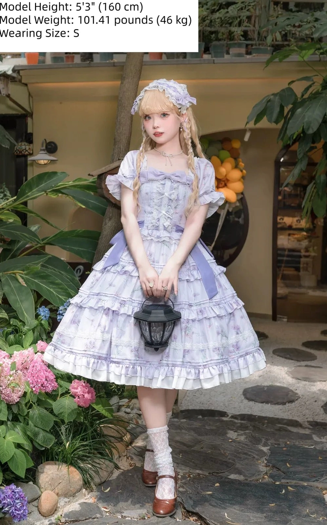 Purple floral chiffon lolita OP dress front view blonde model with matching headband holding mini black lantern layered ruffled skirt lace trim details