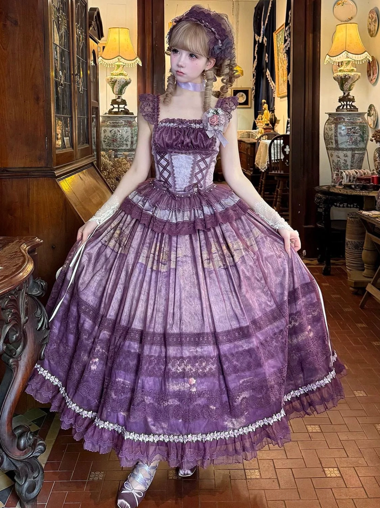 Purple classic lolita ensemble with boned corset bodice, ruffled shoulder straps, printed tulle full skirt, and matching headband, front view in vintage room