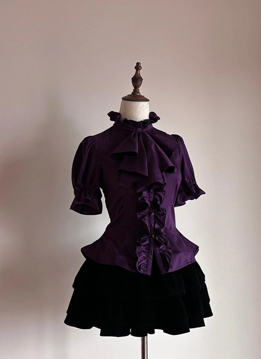 Front flat display of purple Gothic Lolita short-sleeved ruffled shirt with stand collar bow detail and front ruffle button placket on dress form