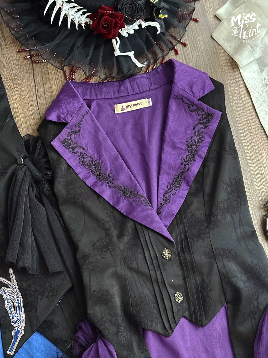 Purple satin lapel Gothic Lolita vest with black embroidery and golden buttons flat lay