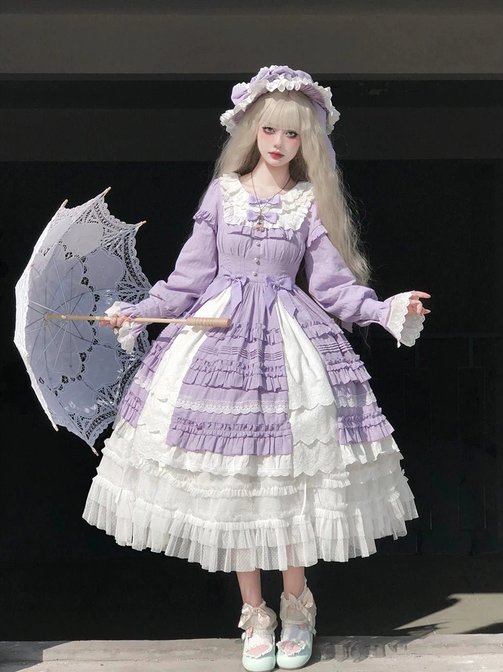Purple lolita dress with white color block, long puff sleeves, frilled neckline, coordinating bonnet, and vintage lace parasol dark indoor backdrop