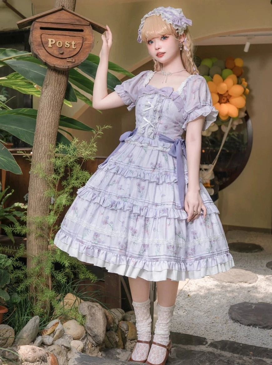 Purple blossom romance classic lolita OP dress full body side view blonde model with flower hair accessory vintage courtyard setting multi-tiered ruffled skirt