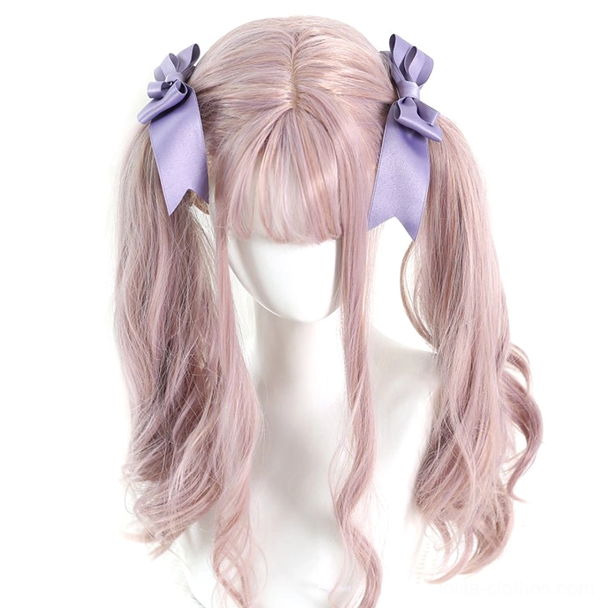 Purple matte satin bow hair clips pair displayed on light purple twin curly wig mannequin showing authentic lolita twin-tail hairstyle