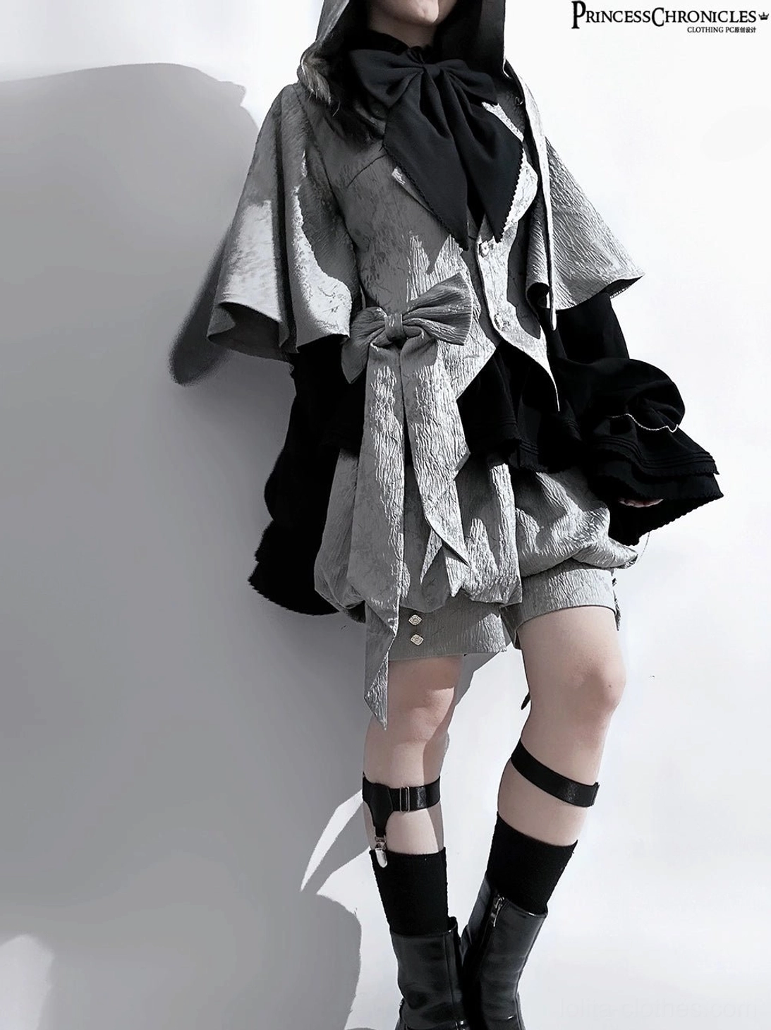 Single model rabbit ear glacier grey ouji lolita suit full front view with black bow tie cropped shorts and leg strap boots